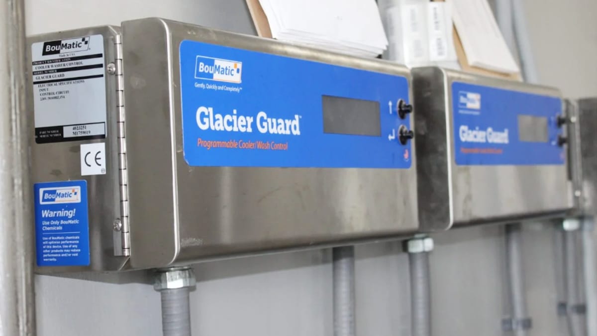 BouMatic Glacier Guard programmable cooler and wash control units mounted on a wall, used for controlling cooling and cleaning processes in dairy operations.